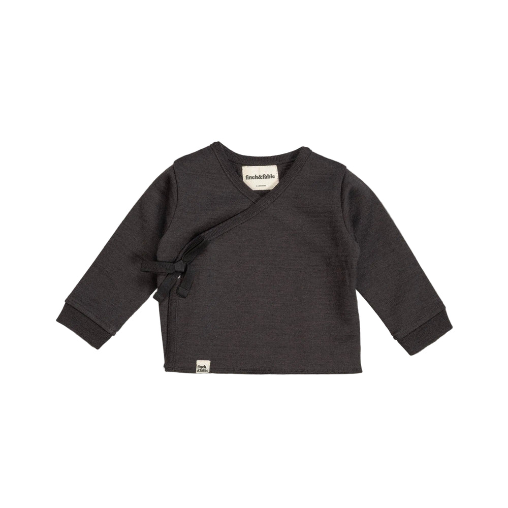 Dark gray baby sweater made of merino wool with a bow on a light gray background