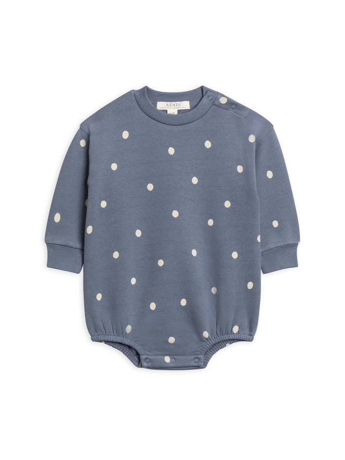 Blue baby romper with white polka dots on a white background