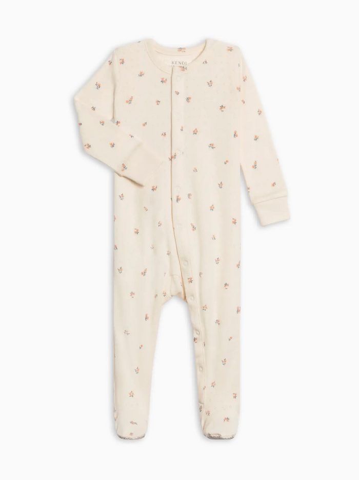 Baby onesie with small patterns on a white background