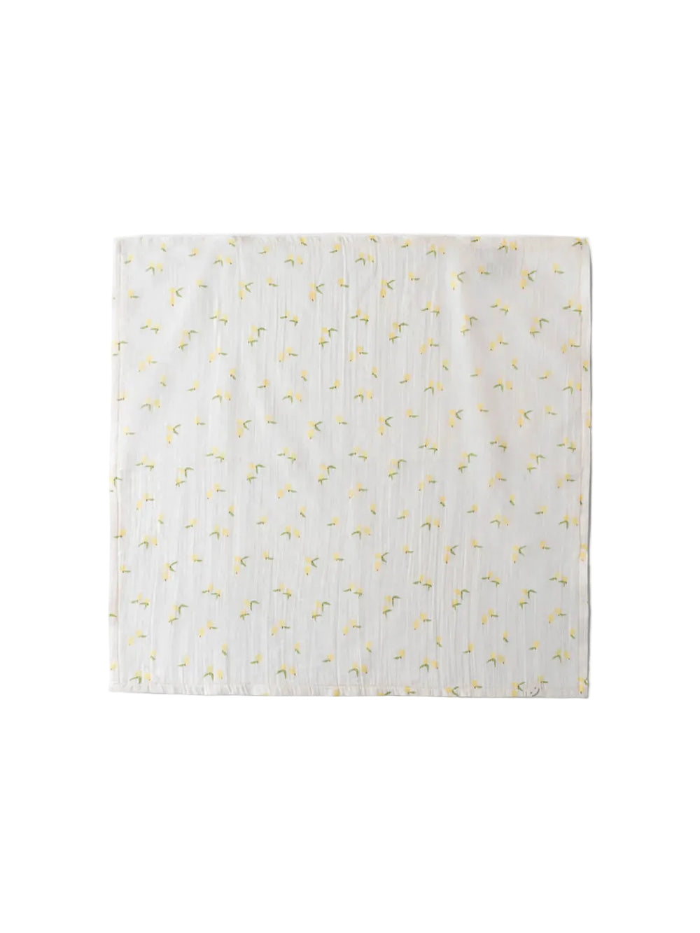 White blanket with yellow floral pattern on a light gray background