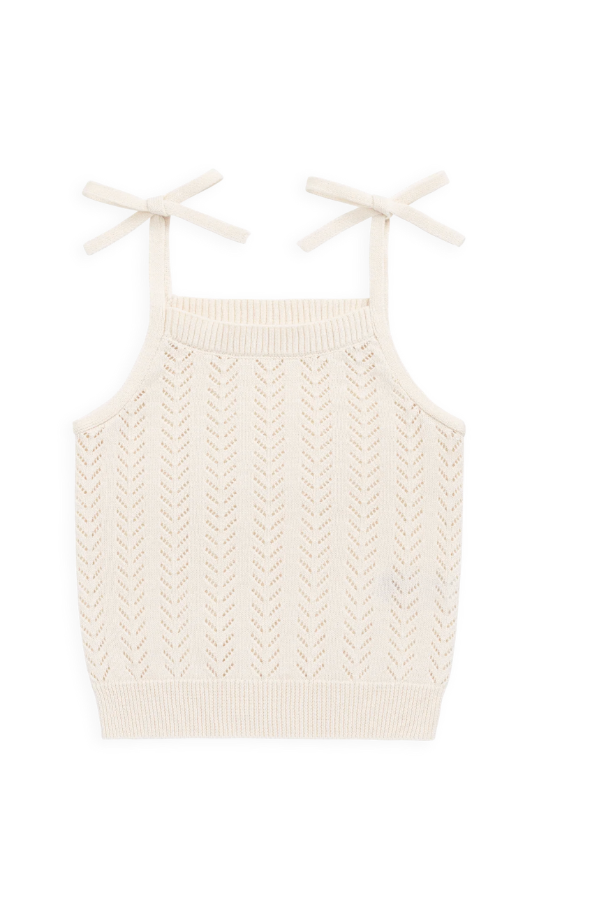 An off-white knit camisole top with a textured chevron pattern and thin shoulder straps tied in bows, shown on a plain white background.