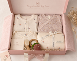 Baby gift set with clothes, blanket, and toys in a pink box, featuring the brand 'KENDI'.