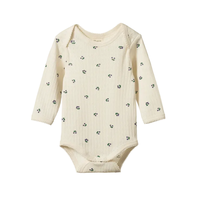 Baby onesie with long sleeves and a floral pattern on a white background