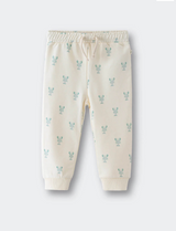 Beige baby pants with small patterns on a white background