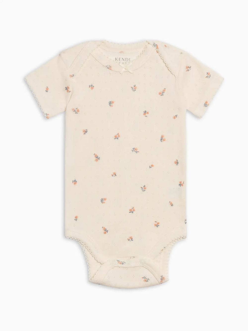 Beige baby onesie with small floral pattern on a white background