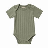Green baby onesie on a white background
