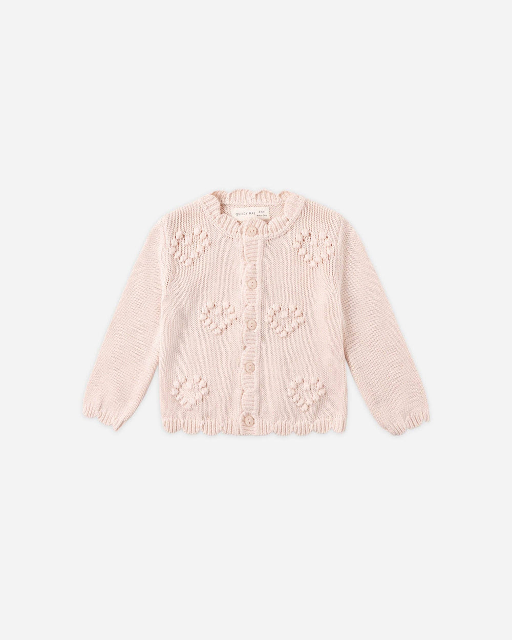 Pink cardigan with floral patterns on a white background