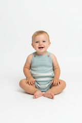 Light blue and white striped baby romper with suspenders on a white background