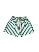 Green and white striped shorts on a light beige background