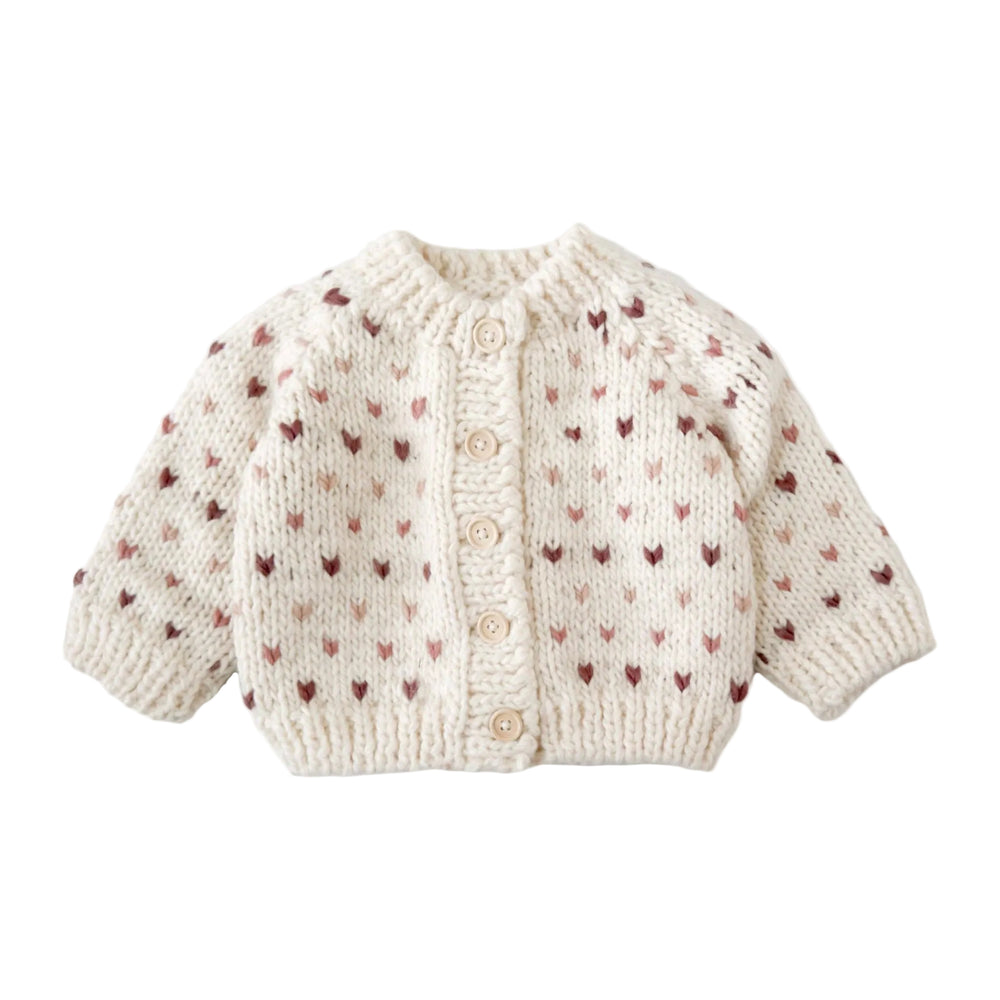 Knitted baby cardigan with heart pattern on a white background