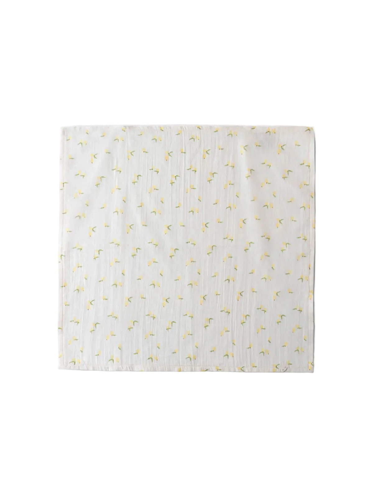 White blanket with yellow floral pattern on a light gray background